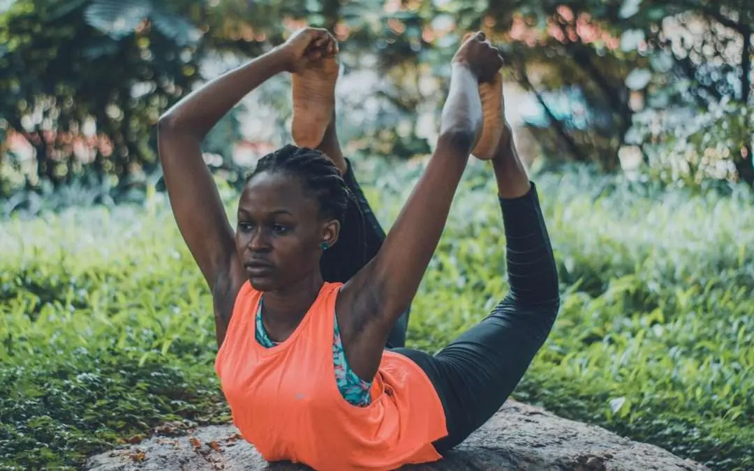 woman doing yoga on rock