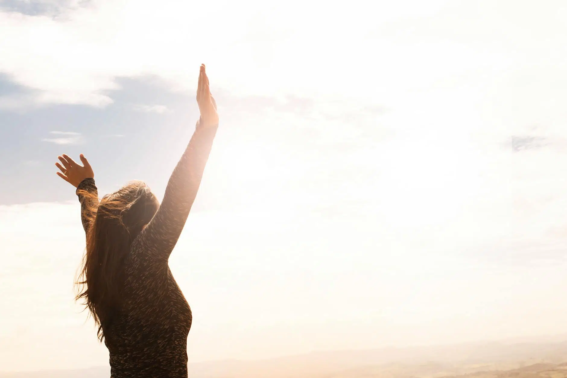 how to reset your life photo of woman raising both hands