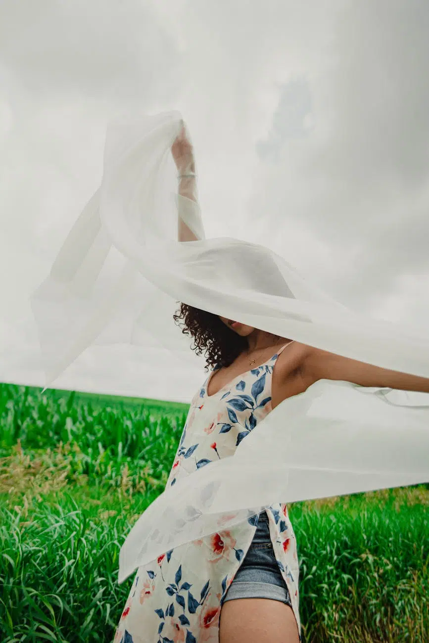 you're not stuck woman in white and blue floral dress lying on green grass field