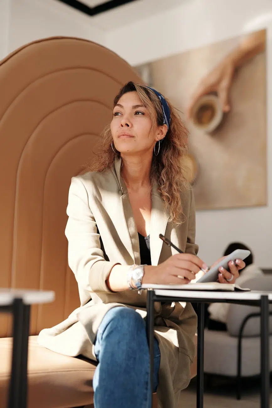 pexels-photo-4063856 woman wearing blazer and blue denim jeans sitting on chair