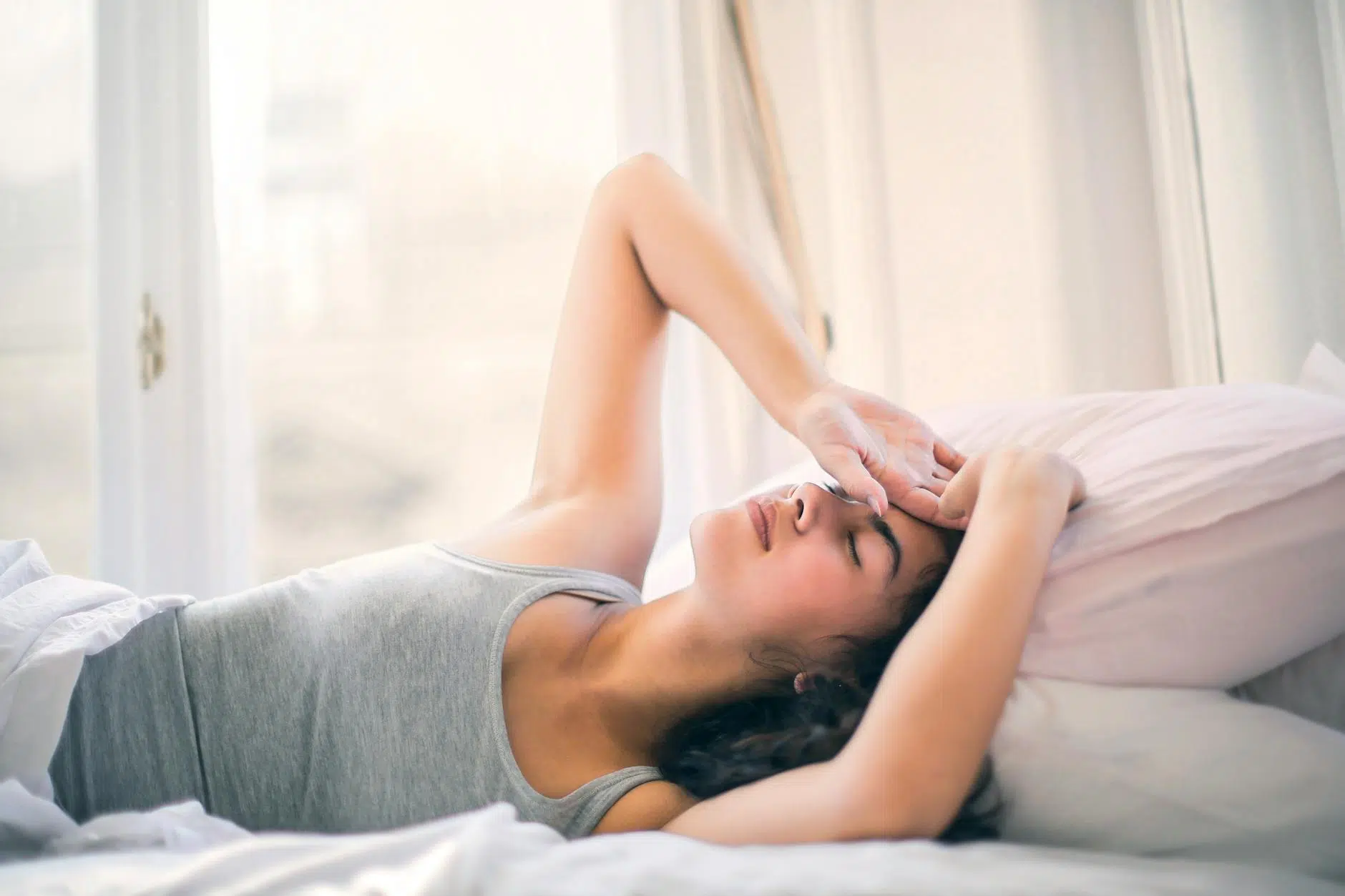 good girl syndrome woman in gray tank top sleeping on white bed