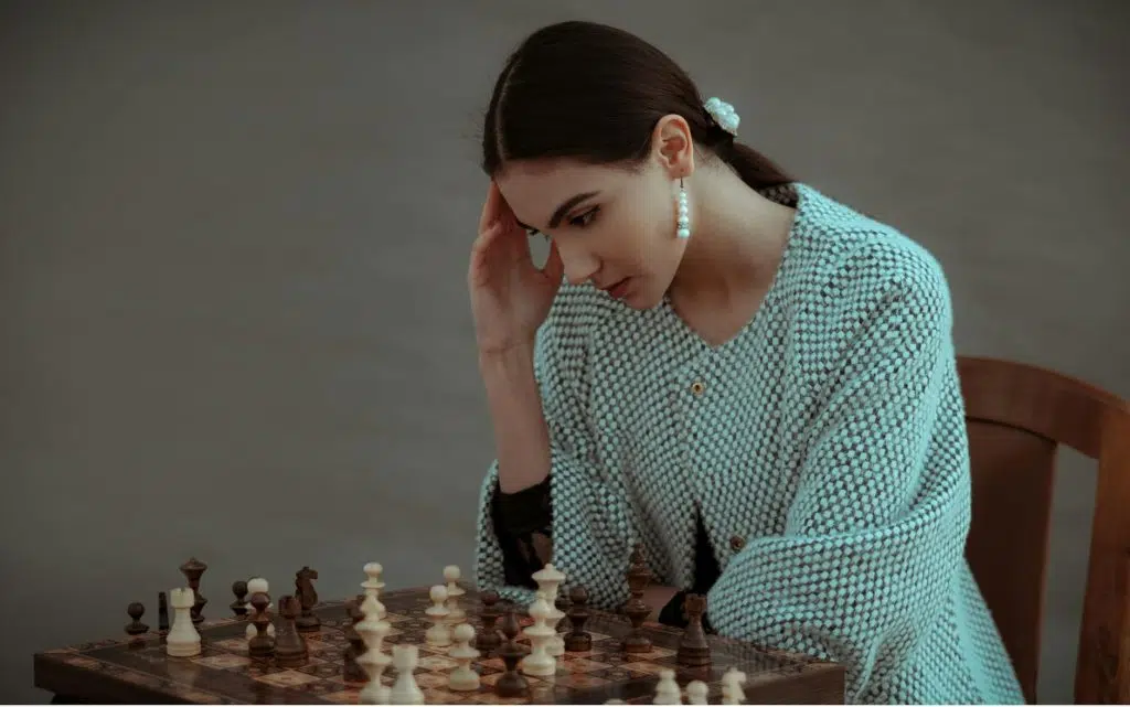 midlife identity shift women pensive ethnic woman thinking on chess move