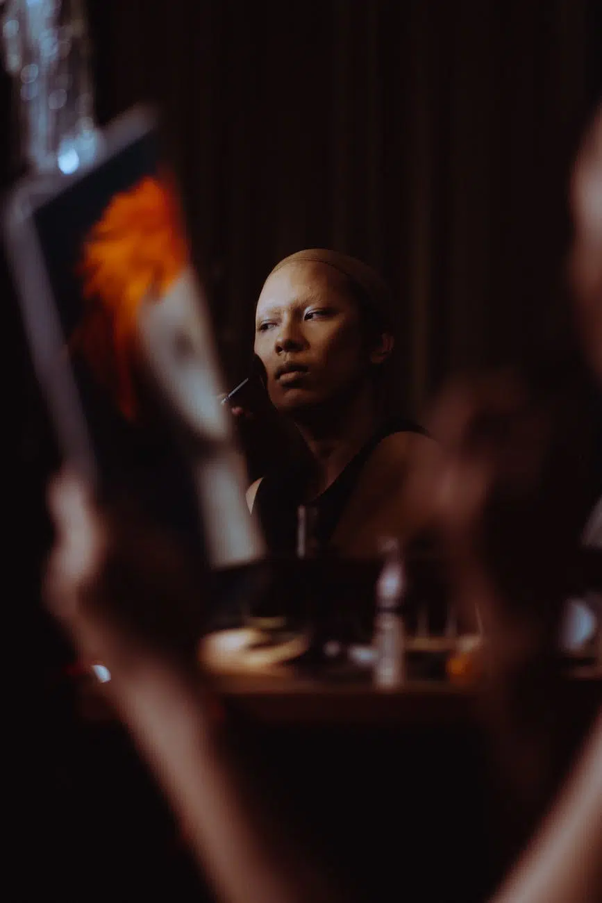 shallow focus of woman applying make up on her face