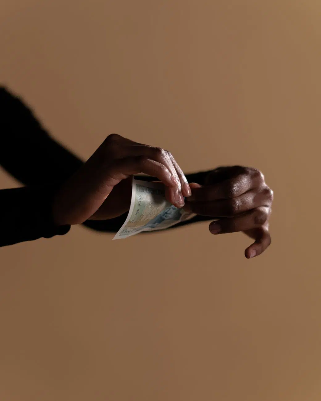 close up shot of a person holding a paper money