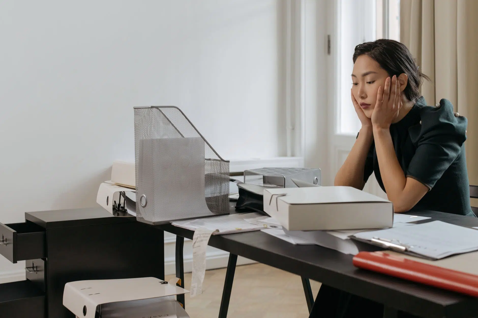pexels-photo-6538431 ptsd after a layoff a woman in the office with her hands on her cheeks